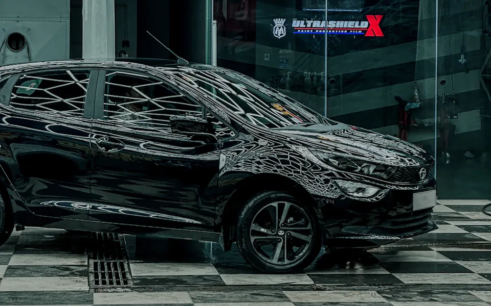 Polished black car in a detailing studio — sample design photography